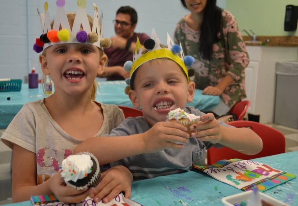 Children eating cupcakes at ArtVille's 14 Birthday Party, May 2018